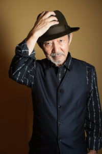 帽子を被った男性がポーズをつけている