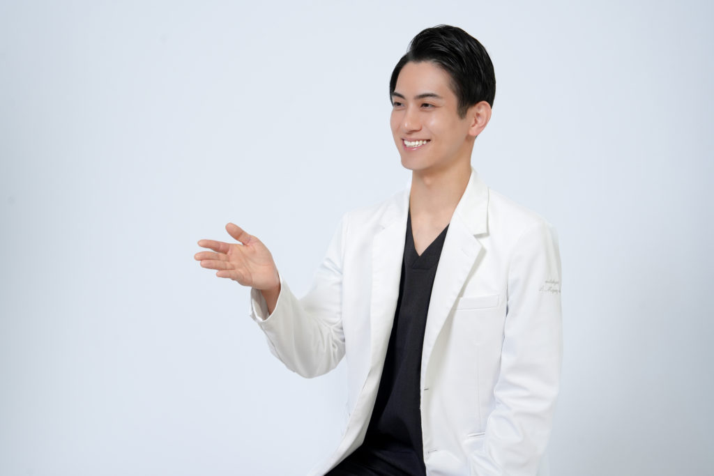 Studio Fictionで撮影した、白色背景で話す男性ドクターのポートレート写真