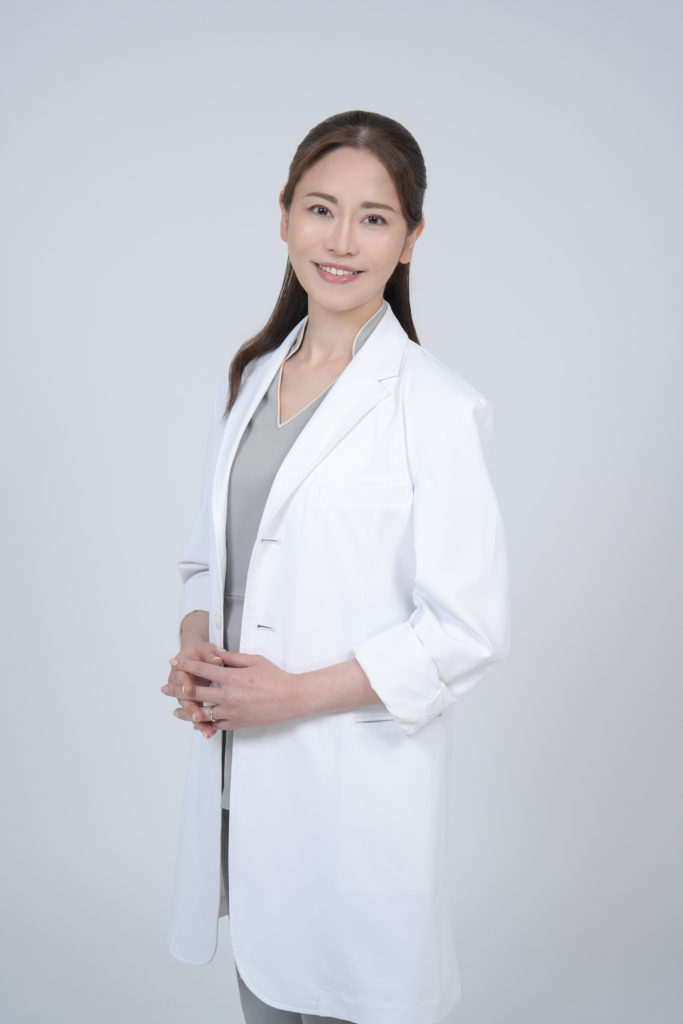 白衣を着た女性が微笑んでいる