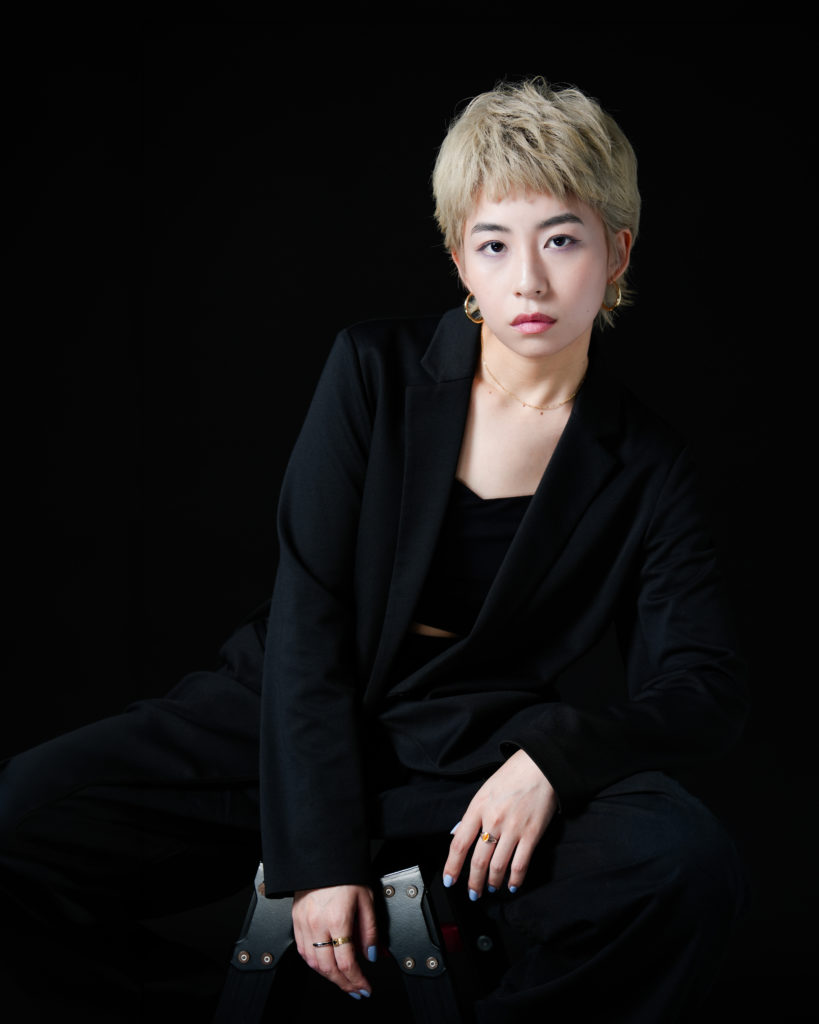 黒背景で金髪の女性のポートレート写真